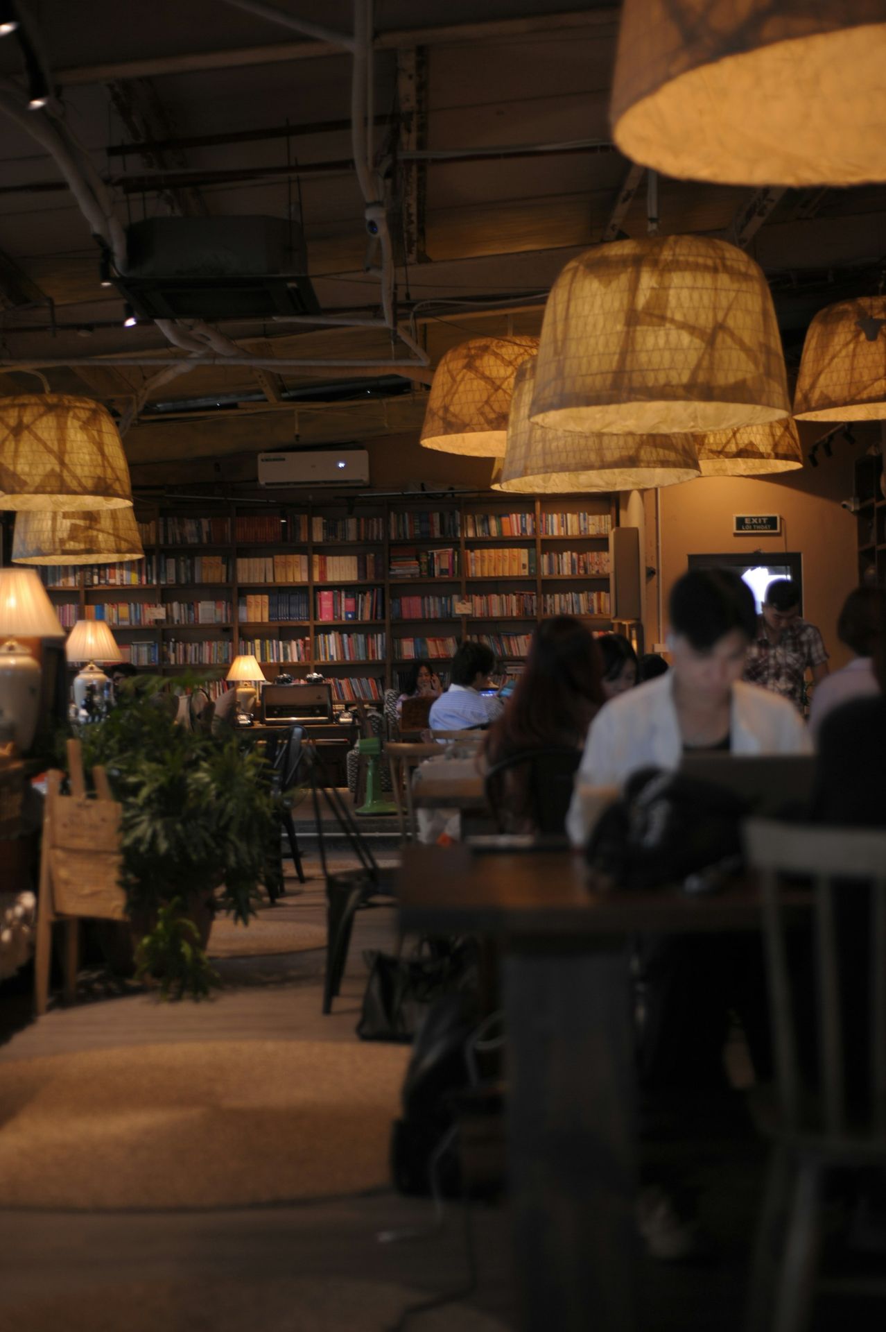A group of people sitting at a table in a library